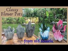 four glass flower pots sitting on top of a wooden table