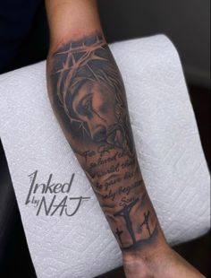 a person with a tattoo on their arm that has a jesus and the word inked in it