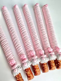 five pink candy sticks with flowers on them are lined up in a row and ready to be eaten