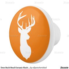 an orange and white deer head knob cover for a car or truck with the word deer head on it