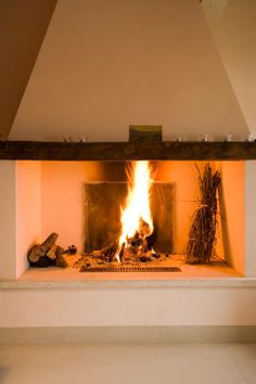 a fire burning in a fireplace with logs