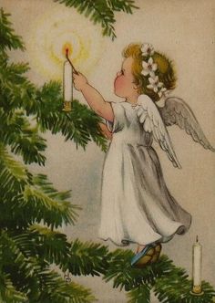 an angel holding a lit candle on top of a christmas tree