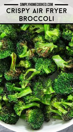 a white bowl filled with cooked broccoli on top of a wooden table and text overlay reading crispy air fryer broccoli