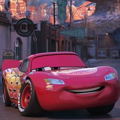 the cars from disney pixars are driving down the street