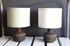 two lamps sitting next to each other on a table