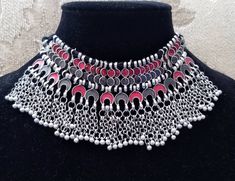 Stand out wearing this striking boho choker in red and soft smokey gray enamel, on oxidized silver so as to create the patina of a vintage tribal piece. Strung on black cotton threads. Maximum length 8 in. Adjustable length using sliding knot, to ensure a perfect fit for you. Wear high up as a choker or lower down, peeking out of a button up shirt. Or on the outside of the shirt. Mesmerizing movement with tiny bells. You will be noticed! And complimented! Shop chokers: https://www.etsy.com/shop/ Grey Boho, Afghan Jewelry, Thread Necklace, Boho Choker, Types Of Gifts, Indian Necklace, Beaded Belt, Sliding Knot, Oxidized Silver