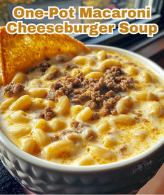 a bowl of macaroni cheeseburger soup with a slice of bread on the side