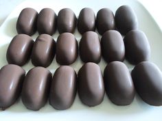 chocolate eggs are arranged on a white plate