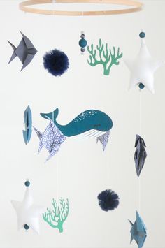 an image of a mobile that is made out of paper fish and starfishs