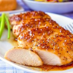 a white plate topped with sliced chicken and green beans