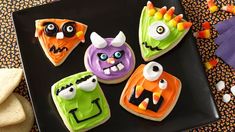 decorated halloween cookies on a black plate