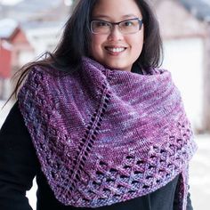 a woman wearing a purple knitted shawl