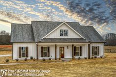 a white house sitting on top of a dry grass field