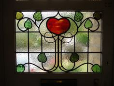 a stained glass window with a heart on it