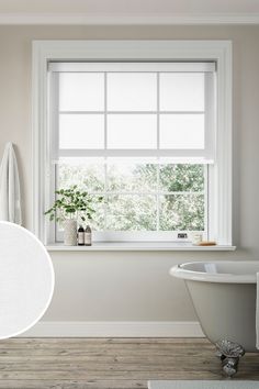 a white bath tub sitting next to a window