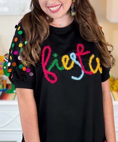 Introducing our "Fiesta Spangle Puff Sleeve Top" in Black, a vibrant and festive addition to your wardrobe perfect for celebrating occasions like Cinco de Mayo, Taco Tuesday, or any Mexican-themed fiesta. This top features a playful design with the word "fiesta" spelled out in metallic letters, adding a touch of sparkle and flair.
Crafted with attention to detail, this raglan puff sleeve top showcases metallic letter spangles that catch the light with every movement, ensuring you stand out in style.
Available in sizes S to XL, this top offers a comfortable and flattering fit for a wide range of body types. The classic black color provides versatility, allowing you to pair it effortlessly with jeans, skirts, or shorts for a chic and festive look.
Whether you're celebrating with friends at a Black Party Tops For Christmas, Black Tops For Christmas Party, Black Christmas Party Tops, Black Christmas Party Top, Fun Black Party Tops, Black Festival Tops For Party, Black Tops For Party Festival, Black Tops For Party And Festival, Fun Multicolor Tops For Party