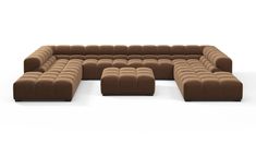 a large brown couch sitting on top of a white floor next to a chair and ottoman