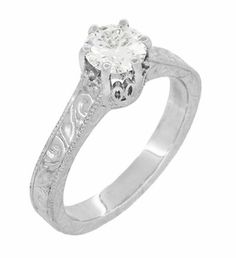 a white gold engagement ring with an engraved design