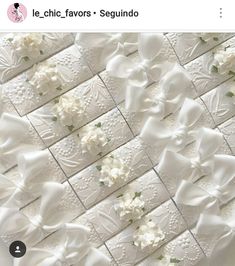 an image of white flowers and bows on a tile wall with the words le chic favors