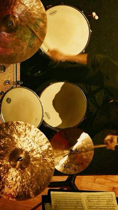 a man is playing drums in front of some music sheets