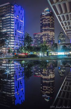 the city skyline is lit up with blue lights