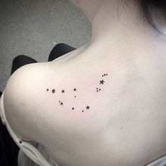 the back of a woman's shoulder with small stars on it