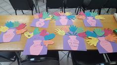 several handprinted cards on a table with chairs