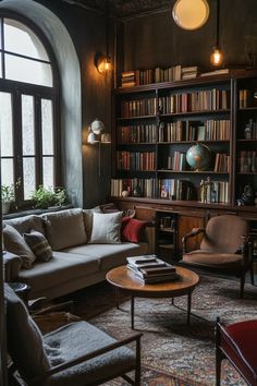 a living room filled with lots of furniture and bookshelves next to a window