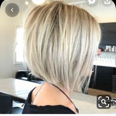 the back of a woman's head with blonde hair in front of a mirror