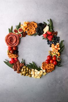 a circular arrangement of fruits and vegetables arranged in the shape of a letter o on a gray background