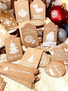 christmas gift tags are laid out on a table