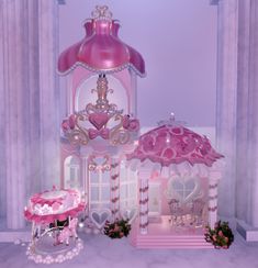 there is a pink and white doll house next to it's stand in the room