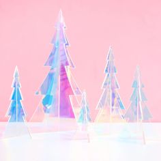 These iridescent 3D acrylic trees come in sets of 5 (one 10" tall, one 8" tall, two 6" tall, and one 4” tall). They are 3 dimensional and reflect light to shine all different colors depending the angle you view them from or what they are around. They are perfect on a mantel or grouped together in a vignette. Iridescent Christmas Decor, Iridescent Christmas Tree, Acrylic Trees, Holographic Christmas, Iridescent Christmas, Christmas Castle, Iridescent Acrylic, Christmas Feeling, Christmas Things