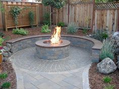 a fire pit in the middle of a backyard