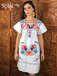 This Beautiful Floral embroidered Dress is the perfect dress to add to your wardrobe. Its cute enough to dress up for a party or even just wear it to a picnic. It's lightweight, handmade out of cotton and is full of vibrant florals. Summer Embroidered Dress With Short Sleeves, Summer Short Sleeve Embroidered Dress, Spring Embroidered Dress With Multicolor Machine Embroidery, Traditional Short Sleeve Dress With Embroidered Border, White Peasant Dress With Geometric Embroidery, White Short Sleeve Dress With Geometric Embroidery, White Geometric Embroidered Short Sleeve Dress, White Short Sleeve Embroidered Dress With Geometric Pattern, White Embroidered Dress With Short Sleeves