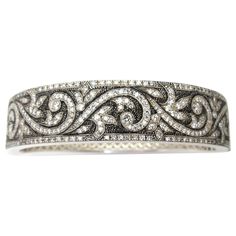 This beautiful sterling silver bangle bracelet is hand engraved with an elegant and ornate scroll design set with 3.50 carats of brilliant, sparkling diamonds! The stippled, blackened background showcases the intricate diamond-studded details, highlighting the rich silver tones. Fine metalwork on the inside of the bangle adds a decorative element while making the bracelet even more comfortable to wear. A lavish, old-world feel, displaying wonderfully modern craftsmanship! 18k Gold Bracelet, Silver Bangle Bracelet, Artisan Bracelets, Sterling Silver Bangle Bracelets, Diamond Bangles Bracelet, Vintage Bangles, Enamel Bangle, Sterling Silver Bangle, Gold Bracelet Cuff