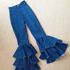 a pair of blue jeans with ruffles on them