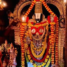 the statue is decorated with flowers and other decorations