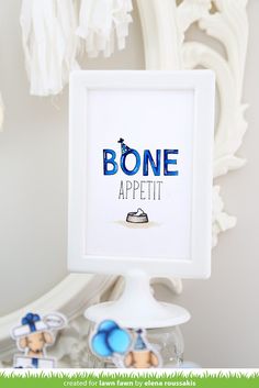 there is a sign that says bone appetit in front of some toys and decorations