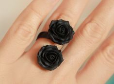 Double Floral ring with two matt black roses . Material of roses- polymer clay. Each petal made by hand. Adjustable base ring in black color about 6-8.5 us/ 16.5-18.5 mm/ 53-59 eur Base of ring is metal Size of flower about 18*18mm/ 0.7 inch DOUBLE RING WITH 2 MATT BLACK ROSES AND STAINLESS STEEL BASE - https://www.etsy.com/listing/957711501 DOUBLE RING WITH 2  BLACK PEARL ROSES AND STAINLESS STEEL BASE - https://www.etsy.com/listing/938930722 BLACK ROSE RING-  https://www.etsy.com/listing/633504133/black-rose-ring-silver-base-ring-polymer?ref=shop_home_active_4&pro=1      Black flowers set jewellery - https://www.etsy.com/listing/740056189/black-flowers-set-jewellery-polymer-clay?ref=shop_home_active_1       Black orchids necklace - https://www.etsy.com/listing/498453721/black-orchids-nec Black Clay Rings, Clay Finger Ring, Black Flower-shaped Rings For Gifts, Black Flower Shaped Rings For Gift, Black Flower Shaped Ring For Gifts, Polymer Rings, Fimo Ring, Black Rose Ring, Rings Clay