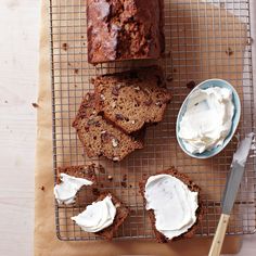 slices of bread and cream on a cooling rack next to a bowl of whipped cream