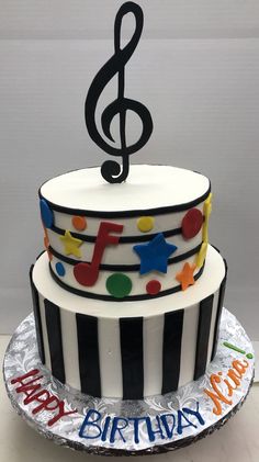 a birthday cake decorated with musical notes and stars