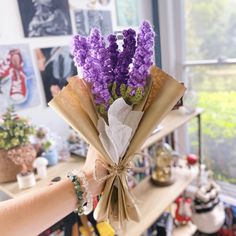 a person holding a bunch of flowers in their hand