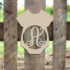 a wooden fence with a monogrammed sign on it