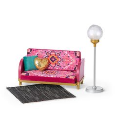 a living room with a pink couch, lamp and rug on the floor in front of it