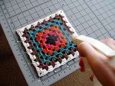 someone is using crochet to make a square