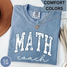 Add a touch of style to your math lessons with the Comfort Colors® Blue Floral Math Coach Shirt! This shirt makes a perfect gift for math teachers and coaches, featuring a beautiful floral design that stands out. Whether you're a math teacher, coach, or enthusiast, this shirt is a great addition to your wardrobe. Soft, comfortable, and uniquely stylish--celebrate your passion for math with this must-have tee! #MathCoach #MathTeacherGift #MathShirt #ComfortColors #FloralDesign #TeacherAppreciatio Blue Relaxed Fit Tops For School, Blue Crew Neck Tops For Back To School, Blue Tops For College Back To School, Blue Letter Print Shirt For School, Blue Cotton Back To School Tops, Blue Short Sleeve Shirt For Back To School, Blue Cotton Top For Back To School, Casual Blue Tops For Back To School, Blue Cotton Tops For Back To School