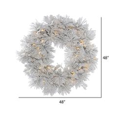 the christmas wreath is shown with lights and snow flakes on it's sides