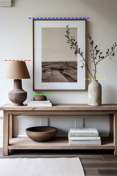 a wooden table with two vases on it and a lamp in front of it