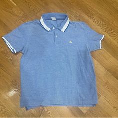 Gorgeous Brooks Brothers Polo Shirt, Unworn Light Blue Collared Casual T-shirt, Casual Light Blue Collared T-shirt, Casual Blue Collared Top, Light Blue Cotton Polo Collar Tops, Blue Cotton Polo Collar Shirt, Light Blue Cotton Polo Shirt For Spring, Spring Light Blue Cotton Polo Shirt, Light Blue Cotton Polo Shirt, Casual Blue Cotton Polo Shirt